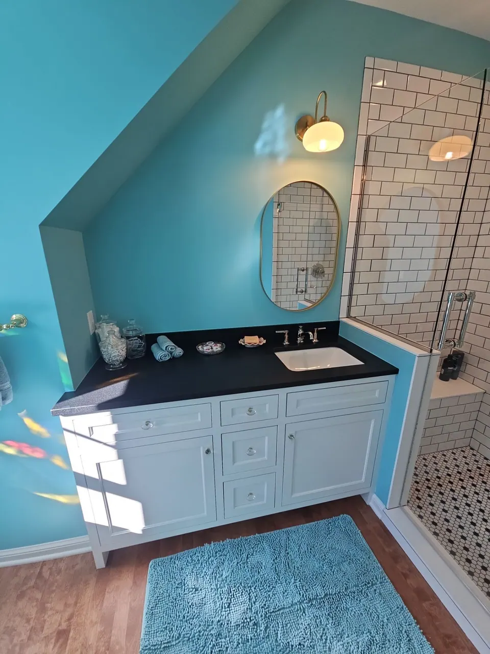 Teal accent wall behind a bathroom vanity