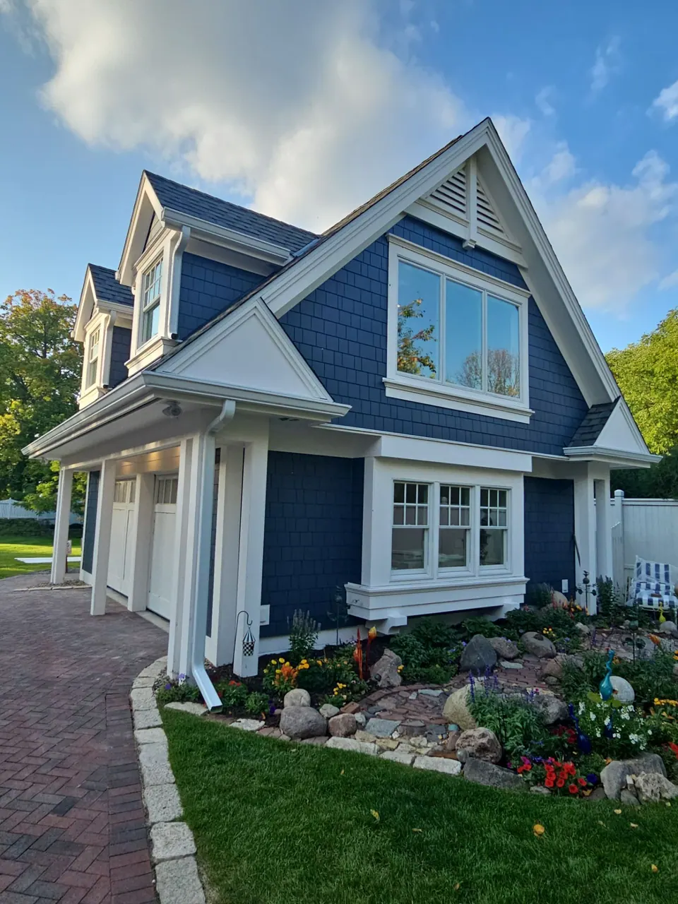 Navy home with a dormer and white window trim