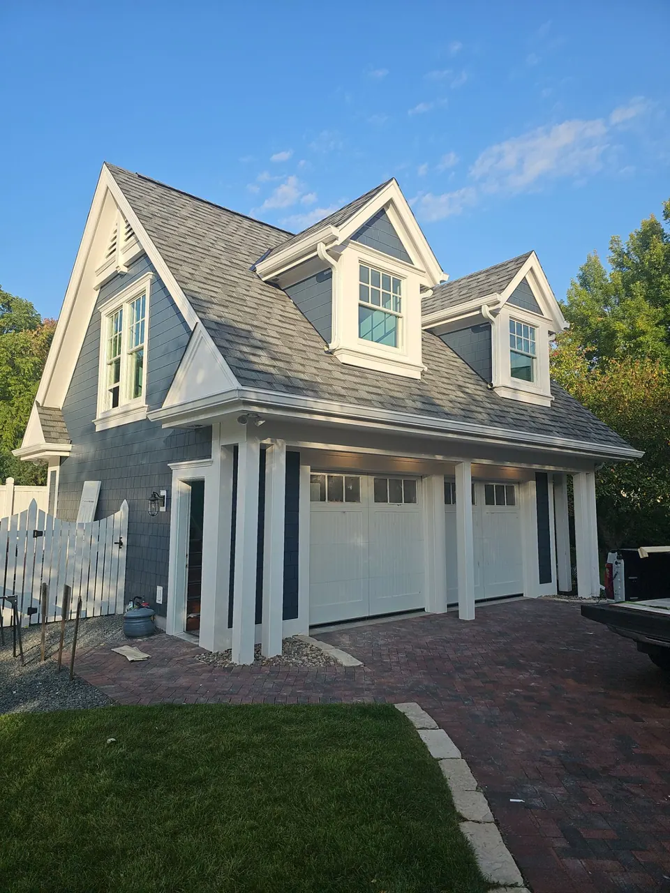 White cottage-style home with blue shutters