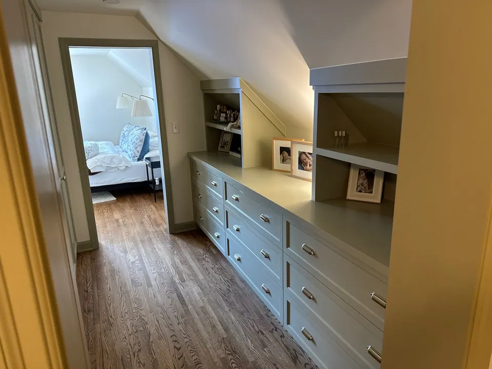 Hallway built-in drawers and shelving painted white in a new home